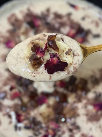 A spoonful of pure bliss. This close-up shows the creamy texture of my coconut-almond milk smoothie, topped with natural ingredients for a truly satisfying treat.