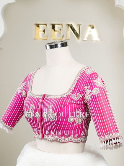Pretty in pink, this raw silk blouse features intricate pearl and silver thread work in a striped pattern. I added floral motifs and delicate danglers on the sleeves for a touch of playful elegance.