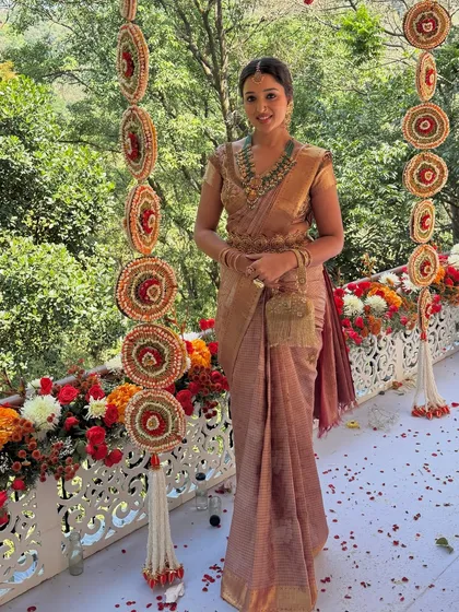 The bride looking absolutely regal in her perfectly draped saree, ready for her muhurtham ceremony.