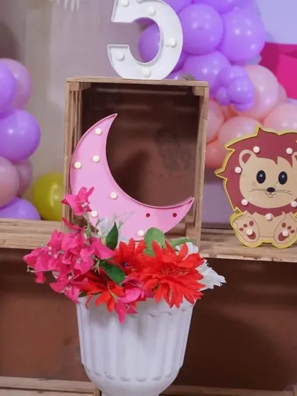 A close-up of some of the props used in my parties, like this cute lion cutout and light-up moon. These small details add a lot of character.