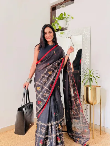 A black saree with a beautiful embroidered border. This is a more formal workwear option, perfect for important meetings or office events.