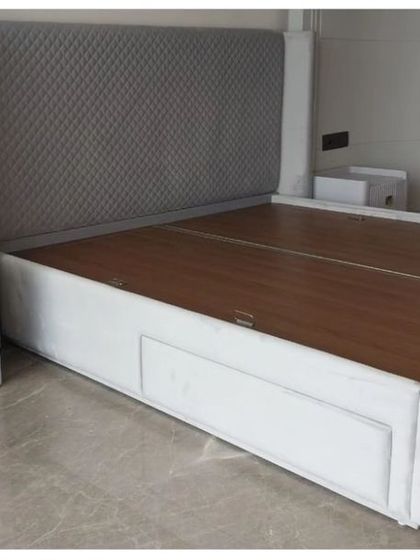 A sleek, modern bed with a diamond-patterned tufted headboard and a low-profile frame with built-in storage drawers. Paired with a minimalist white nightstand, this set is perfect for contemporary, functional living.