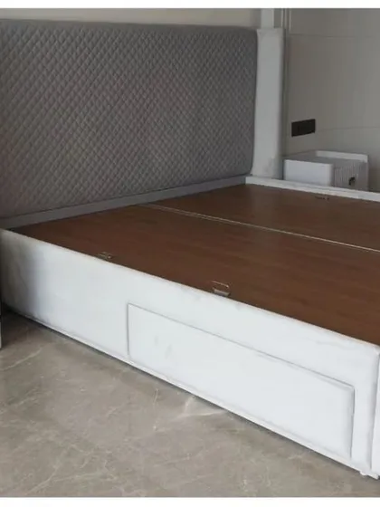 A sleek, modern bed with a diamond-patterned tufted headboard and a low-profile frame with built-in storage drawers. Paired with a minimalist white nightstand, this set is perfect for contemporary, functional living.