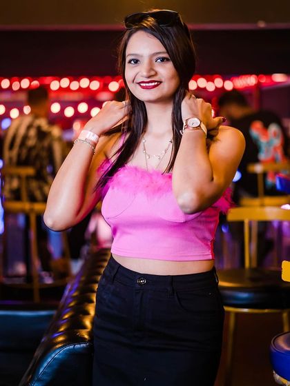 A guest in a pink top, matching the party's fun vibe.