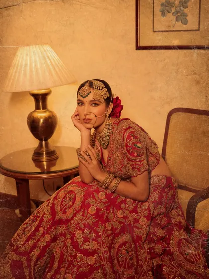 A vintage-inspired shot of the bride. The editing and pose, combined with the traditional styling, create a feeling of old-world charm and elegance.