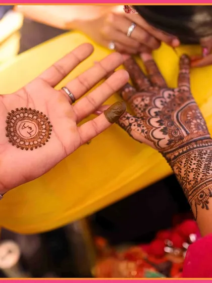 Henna designs and heartstrings, perfectly intertwined. A close-up of the couple's hands, showcasing their beautiful Mehendi.