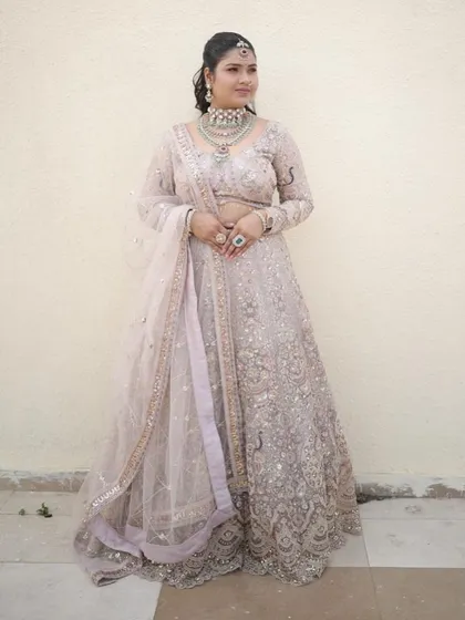 This pastel lehenga with delicate silver work is perfect for a daytime wedding or engagement. The full sleeves and intricate detailing are simply beautiful.