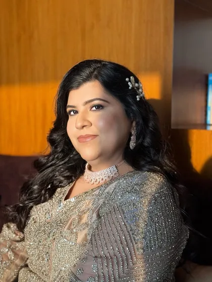 A confident and poised portrait. The makeup is timeless and sophisticated.