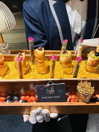 We believe every detail matters. Here, our impeccably dressed server presents our signature Avocado Toast, creatively served in glasses with accompanying flavour droppers. It's this commitment to innovative presentation and service that elevates every moment of your event.