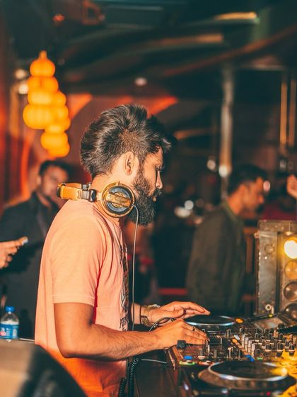A side profile of me at the decks at Badmaash Lounge, concentrating on the mix.