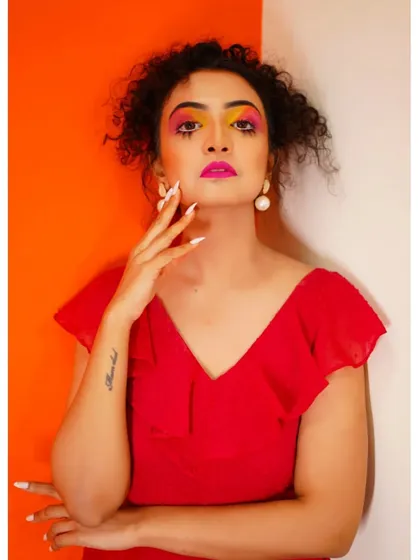 A vibrant, colorful makeup look for a color photography project, featuring bright yellow and pink eyeshadow.