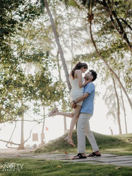A classic, joyful lift against a backdrop of lush Thai palm trees. This shot is full of energy and romance, perfectly capturing the carefree spirit of a destination pre-wedding shoot in Phuket.