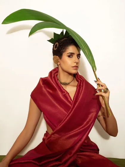Another angle from the same series, this time using a large leaf as a prop to interact with the frame. It adds a playful yet poised element to this modern-traditional portrait.