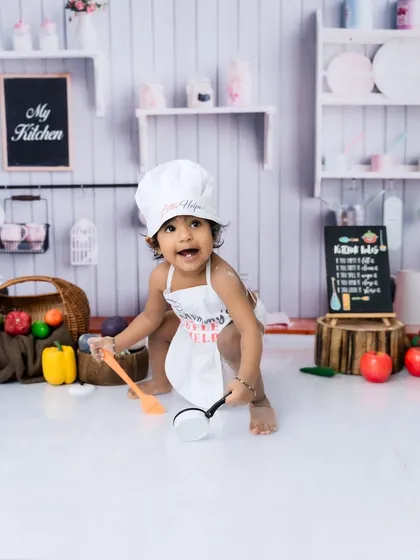 Exploring all the fun props in the mini kitchen. I provide everything needed for these creative toddler photoshoots.