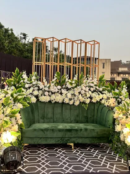 A close-up on the rich texture of the velvet sofa, framed by beautiful white flowers.