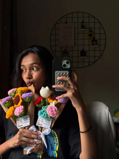 Me trying to look cool while holding the bouquets I just stress-made in 24 hours. The life of a crochet artist is chaotic but colorful.