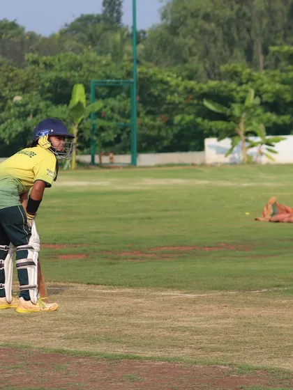 A batter takes her stance, ready to face the bowler in a practice match.
