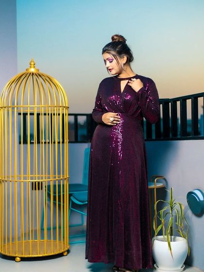 Another angle from the purple gown shoot, showing the full outfit and how the bold eye makeup completes the glamorous, party-ready look.