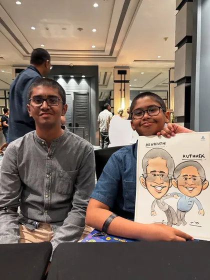 Two brothers happily showing off their caricature. It's a great way to entertain younger guests at parties and give them a unique keepsake.