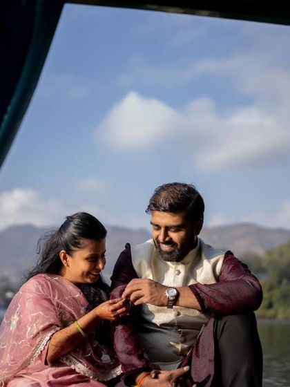 The couple sharing a private, happy moment on the boat, framed by the curtains of the shikara.