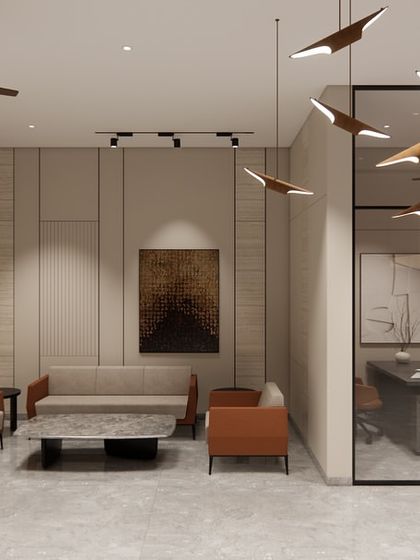 This seating area within the Shilpa Rathna Clubhouse features clean lines and a balanced composition. A glass-walled meeting room provides a private space for discussions without visually closing off the lobby.