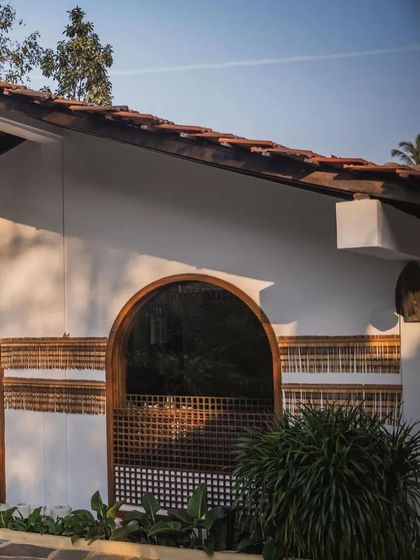 A view of the arched windows and bamboo-detailed walls at Sanctuary Bar, showcasing the blend of traditional Portuguese and local Goan design elements.