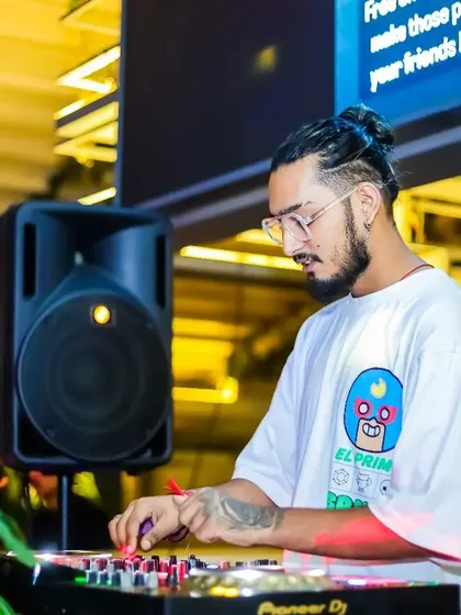 Sporting a different look with a man bun, I adapt my style to the event's vibe while staying focused on the music.