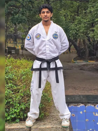 I am standing in a formal Taekwondo attention stance, representing the discipline and tradition of the art.