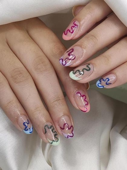 This design uses negative space with colorful, squiggly outlines on each nail. It's a fun, modern, and slightly retro look that is completely hand-painted.