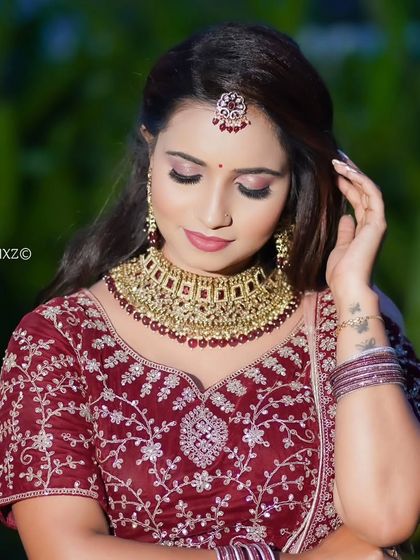 A beautiful portrait of a bride wearing a Kundan choker set. The red stones add a touch of traditional color.