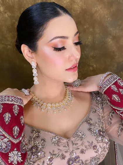 Here is a close-up of my signature HD makeup technique. I focused on creating luminous, glowing skin, a sharp winged eyeliner, and soft pink lips to complement the client's elegant engagement outfit. This look is all about sophisticated glamour that looks incredible in photos.