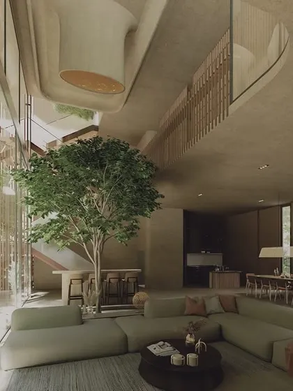 The Sanctuary, a wellness pavilion in Hyderabad, features this open-plan living space designed around a central tree. The use of structural timber and floor-to-ceiling glass creates the feeling of an urban oasis, blending the comfort of the indoors with the serenity of nature.