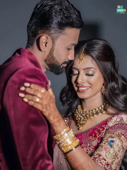 A romantic moment between the happy couple. The makeup is designed to look flawless both in person and in professional photos.