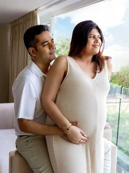 A tender embrace by the window. At-home sessions allow for these comfortable, natural interactions.