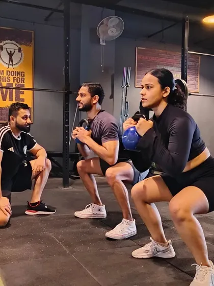 Training is always better together. Here, we're guiding two clients through a synchronized kettlebell squat, focusing on depth and form. Whether you're training with a partner or in a small group, we build a supportive environment where everyone pushes each other to get stronger.