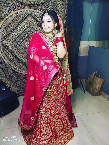 This bride chose a traditional red lehenga with intricate gold work for her wedding. Renting allows you to wear such a heavily embellished designer piece for a fraction of the cost.