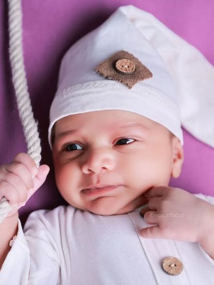 An adorable awake moment captured during our celestial swing photoshoot. We are skilled at photographing babies whether they are asleep or curiously looking around.