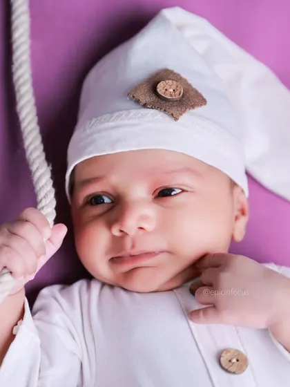 An adorable awake moment captured during our celestial swing photoshoot. We are skilled at photographing babies whether they are asleep or curiously looking around.