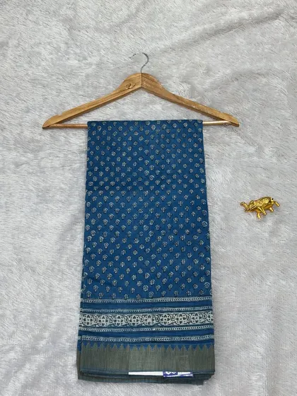 A classic blue Bagru printed saree on Chanderi silk. The small, delicate bootis and the simple border make it a perfect choice for elegant daily wear or office wear.