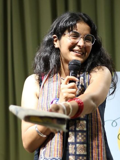 A host playfully interacts with the audience, creating a fun and lighthearted vibe.