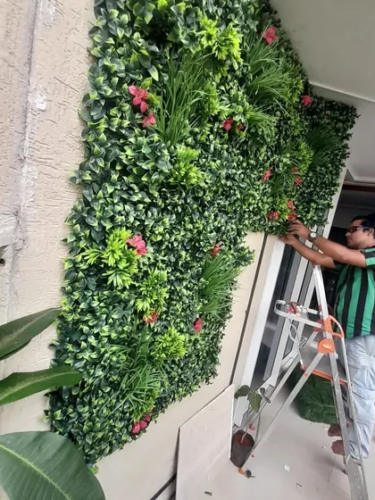 Here I am, setting up an artificial vertical garden for a client in Bangalore. My team and I handle the entire installation process, so you don't have to worry about a thing.
