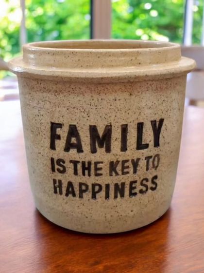 While I often create branded items, I also craft pieces with custom messages. This caddy, with the quote "Family is the key to happiness," shows the versatility of personalizing ceramics for any theme.