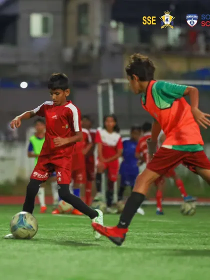 An intense training drill under the floodlights. Our elite training grounds are where future stars are made, providing the perfect environment for success.