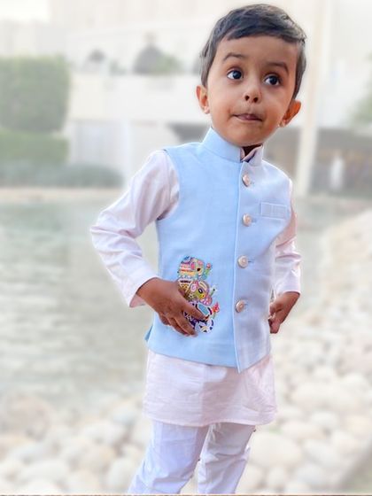 Meet Sharav, our 3-year-old style icon. His light blue bandi features a custom hand-embroidered elephant, his favorite animal, proving that personalized style knows no age.