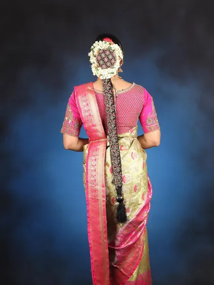 A detailed look at the traditional South Indian bridal braid, an essential part of the look that we also teach in our hair styling courses.