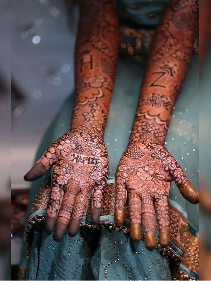 This bride's mehendi tells her story with her name 'Hafiza' and the couple's initials 'H' and 'Z' incorporated into the design.