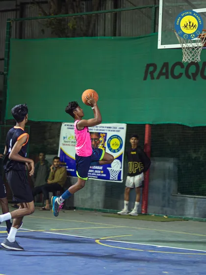 Feel the thrill of the game under the lights. This action shot from a night match on our basketball court captures the intensity and passion our players bring to every game.