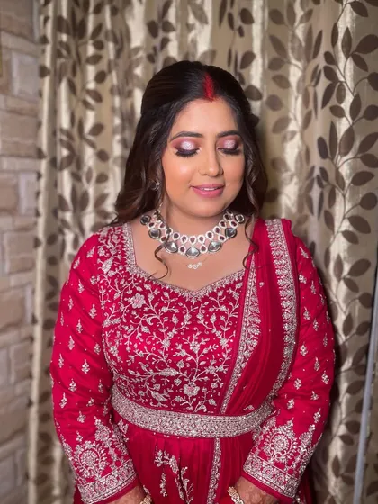 A close-up of the reception look, showing the dramatic pink and black smokey eye.