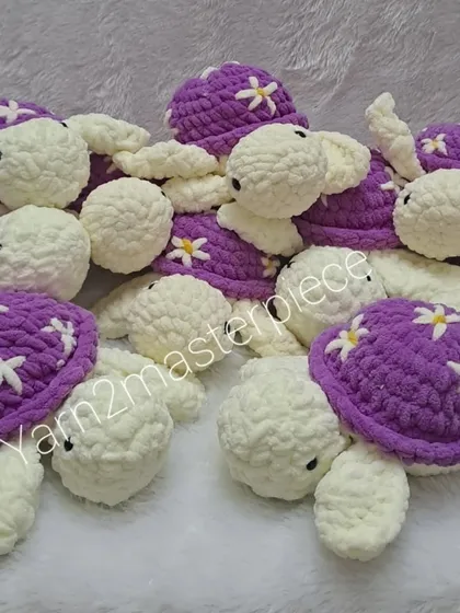 These purple and white turtles are decorated with little daisy flowers on their shells, giving them a sweet, springtime feel.