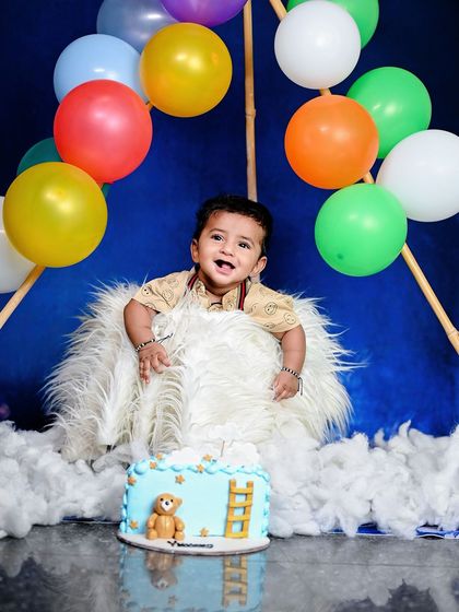 A colorful hot air balloon themed cake smash for a first birthday.